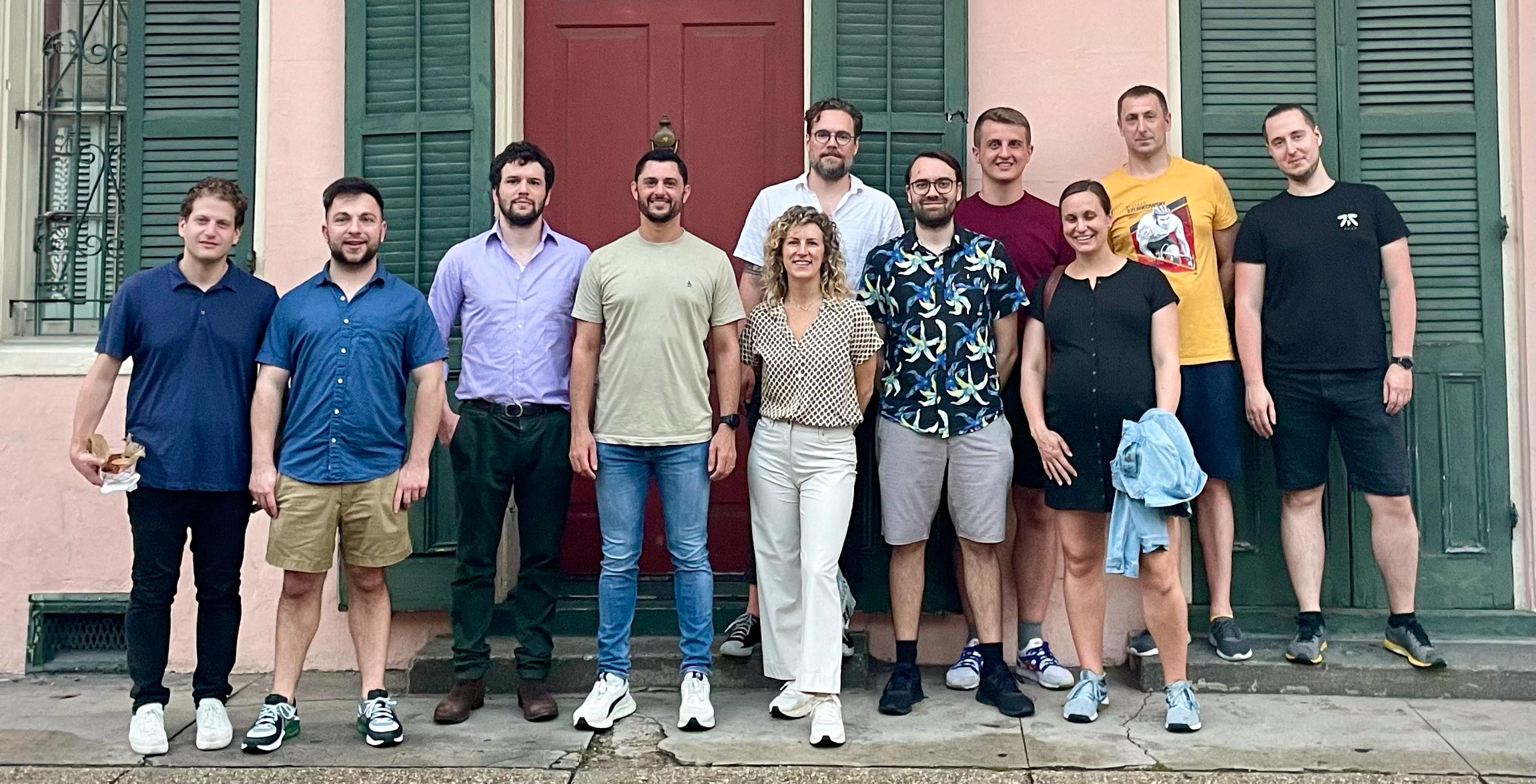 The Plural team standing together on a sidewalk in the French Quarter of New Orleans.